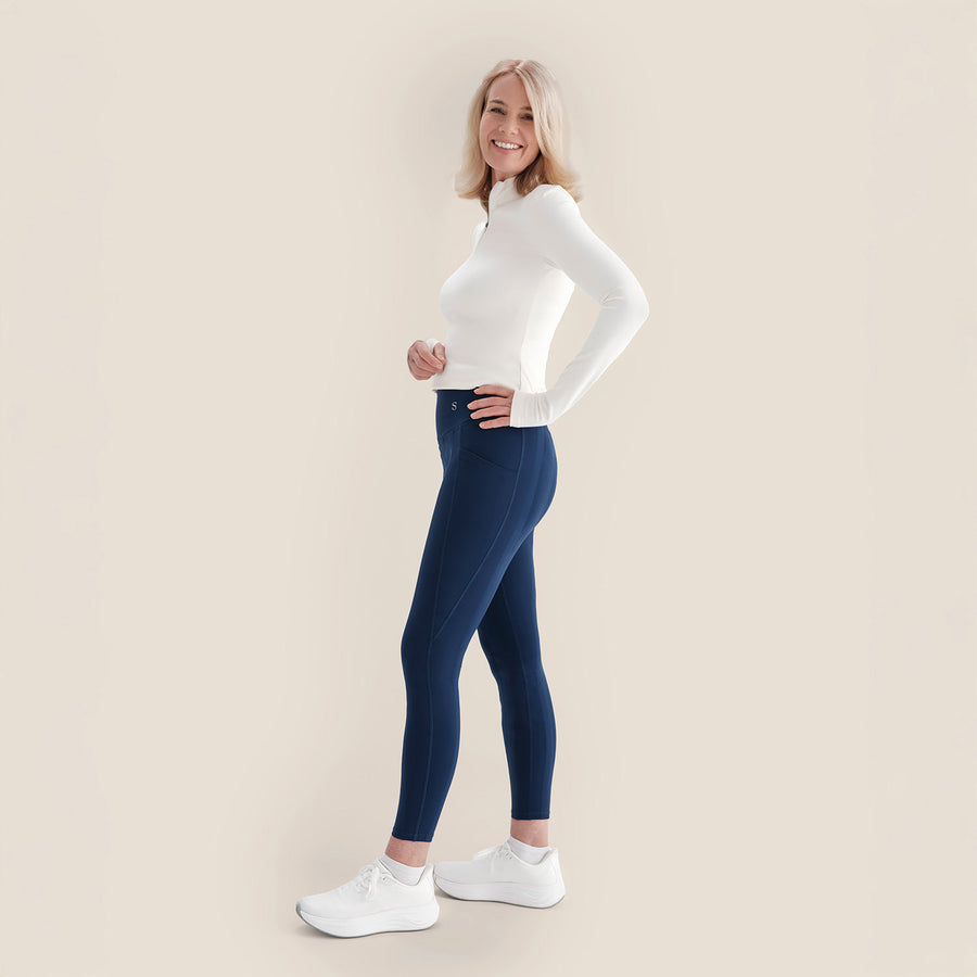 Smiling woman in her fifties wearing navy Skinnify leggings