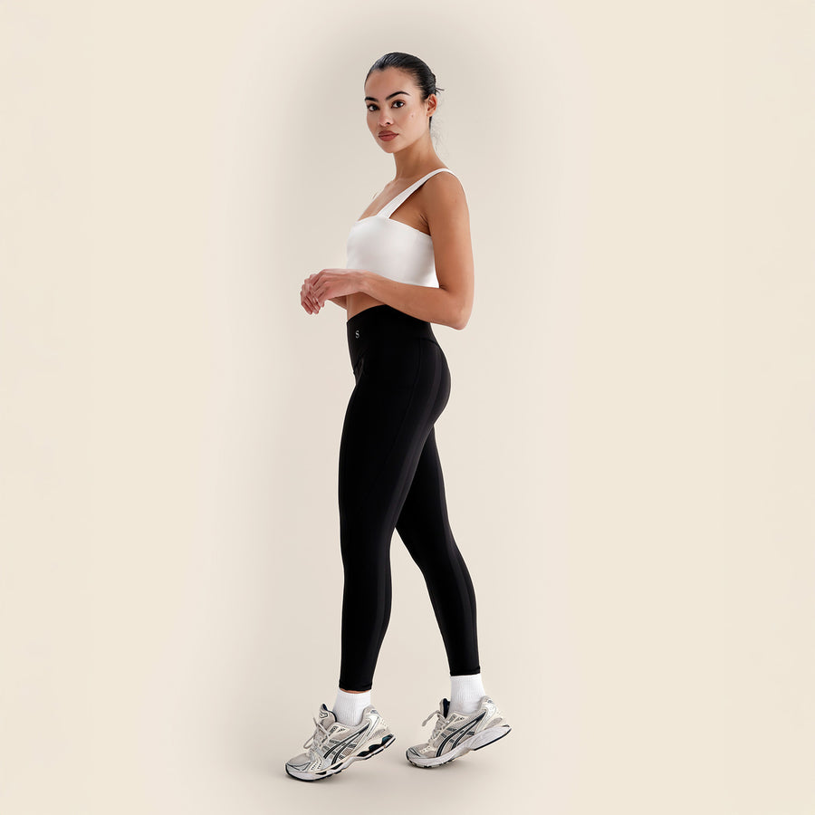 Skinnify resistance band leggings worn with sneakers, side view